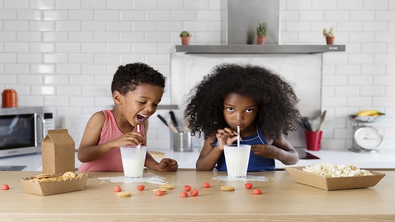 دو کودک در حال نوشیدن شیر